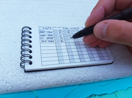 Recording swimming lengths and strokes on the wet Pocket Gym Diary.