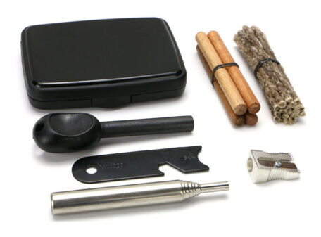 The Spitfire pocket fire lighting kit. A black plastic box, a chunky ferrocerium rod with handle, a steel striker, a telescopic pocket bellows tube, a pencil sharpener for making tinder, a bundle of waxed jute and some waxed wooden dowels. All laid out on a plain white background.