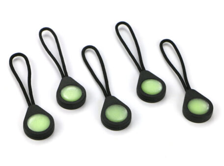 Five Glo Zip glow-in-the-dark zipper pulls arranged on a plain white background.