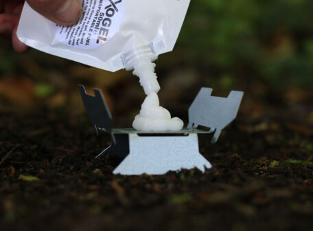 Exogel Camping Stove Gel Fuel being dispensed from the pouch onto the Emergency Stove, during a woodland hike.