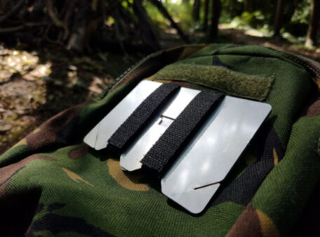 The Stealth Stove packed up and attached with the hook and loop straps to a military camo pouch.