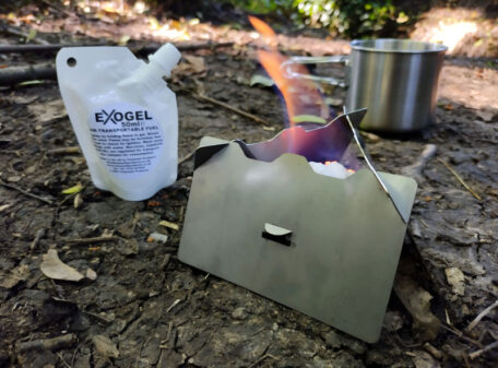 The Stealth Stove burning Exogel Camping Stove Gel Fuel, whilst camping in the woods near a stream.