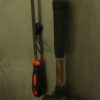 Two MagLoops affixed to a stainless steel surface, holding up a hammer and a file.