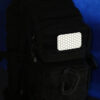 The glinting Cyflect Patch, attached to a tactical black rucksack.