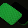 Two Cyflect Patches laying back to back, glowing in the dark with a bright green glow.