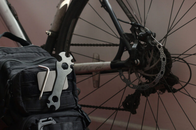 The Mag Patch affixed with hook and loop to a small backpack, being used to hold bike tools for maintenance while cycling.