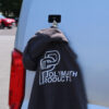 The Mag Patch magnetically attached to the side of a camper van, with a jacket affixed to it with hook and loop.