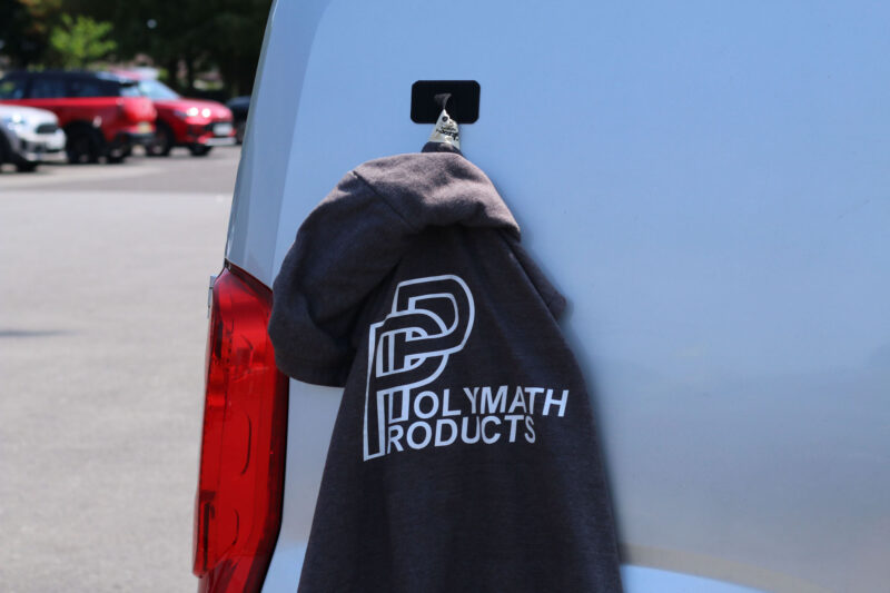 The Mag Patch magnetically attached to the side of a camper van, with a jacket affixed to it with hook and loop.