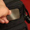 The Mag Patch being affixed with hook and loop to a tactical black backpack.