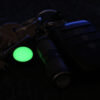 A Magnetag attached to a bunch of keys, glowing bright green in the dark as a gear marker.