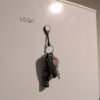 A Magnetag being used to hang a bunch of keys from a fridge.