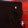 A Magnetag attached to the side of a desktop computer, being used as a USB cable tidy.