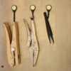 Three tools, each hanging from a Magnetag, which are magnetically attached to a steel surface.
