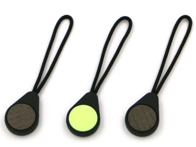 Three Magnetags, showing both the neodymium magnet surface, and the rear glow-in-the-dark marker, on a plain white background.