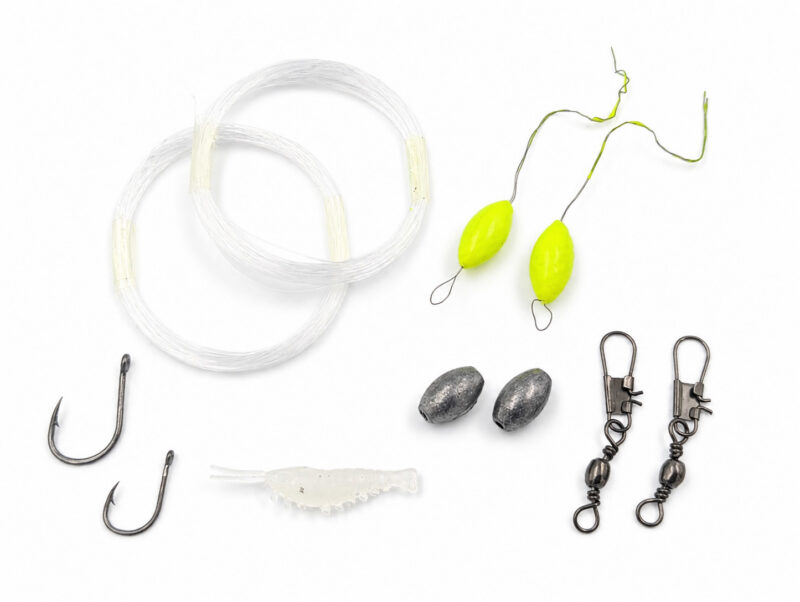 The Mini Survival Fishing Kit's contents laid out neatly on a plain white background.